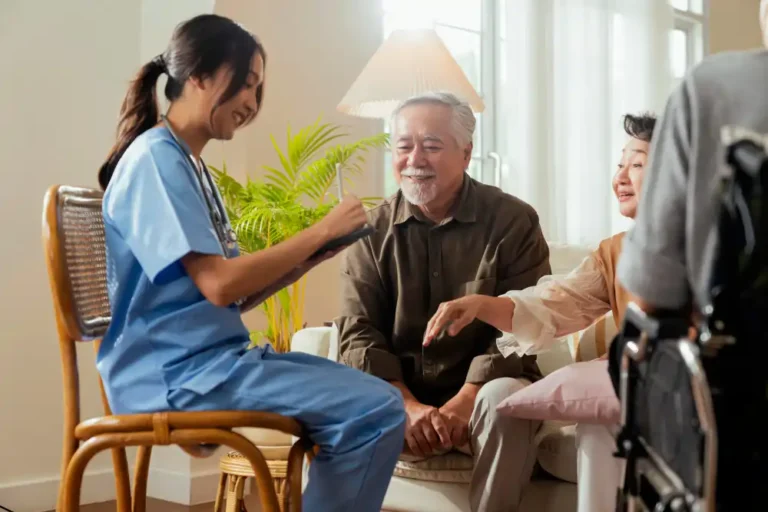 happiness-cheerful-elderly-woman-men-talking-with-female-caregiver-nurse-doctor-having-health-checking-consult-living-areacaretakers-with-senior-couple-sitting-living-room-nursing-home
