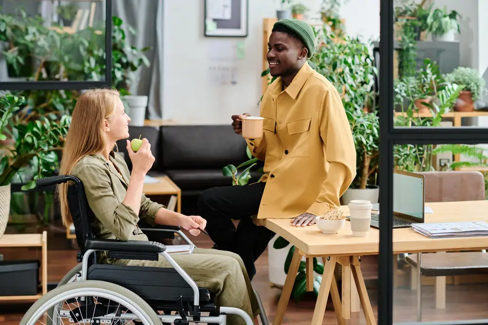 two-young-intercultural-employees-discussing-working-points-lunch-break