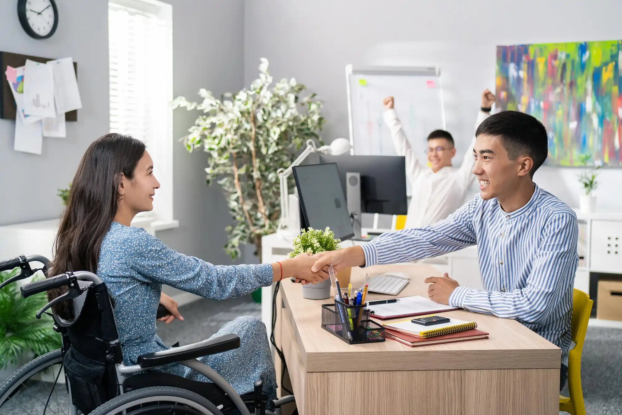 woman-who-use-wheelchair-desk-office-across-from-her-employer-is-holds-out-hand-1
